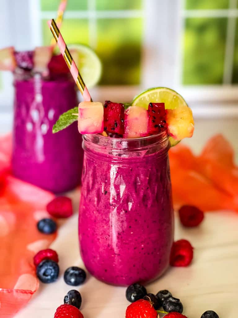 dragon fruit smoothies with fruit on top.