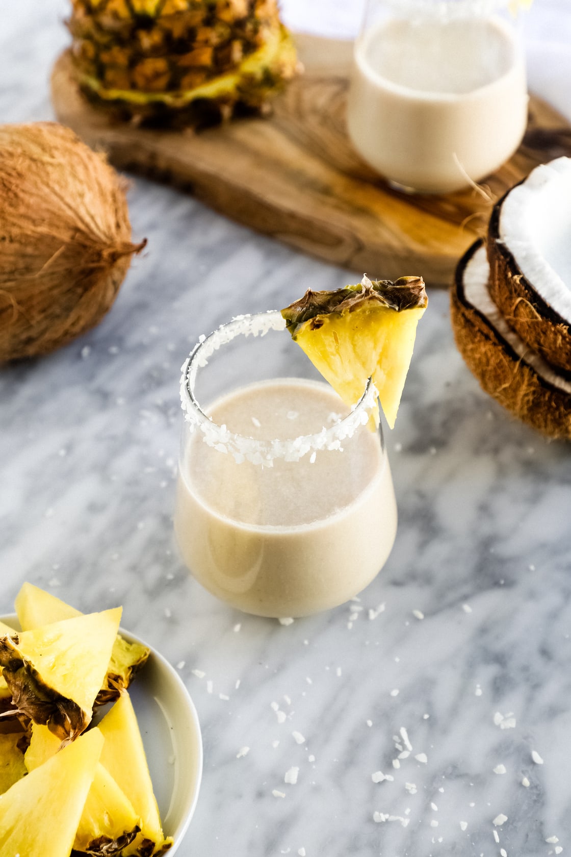 pina colada smoothies with pineapple on the side.