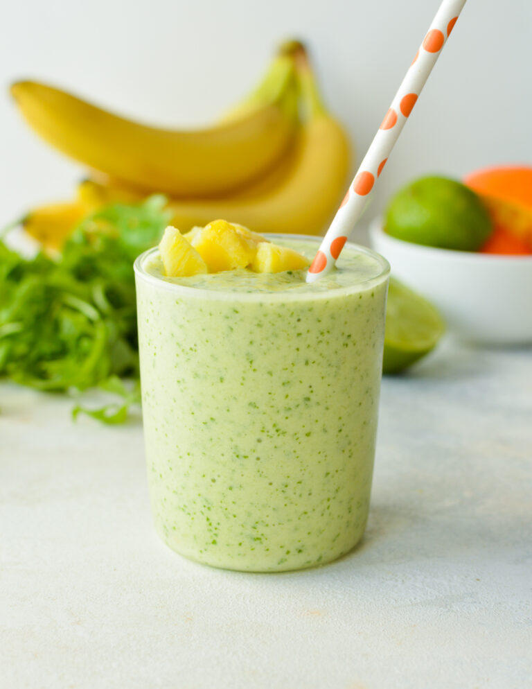 arugula smoothie with pineapple on top.