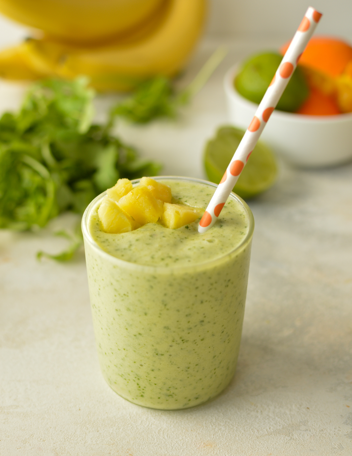 arugula smoothie with pineapple on top. 
