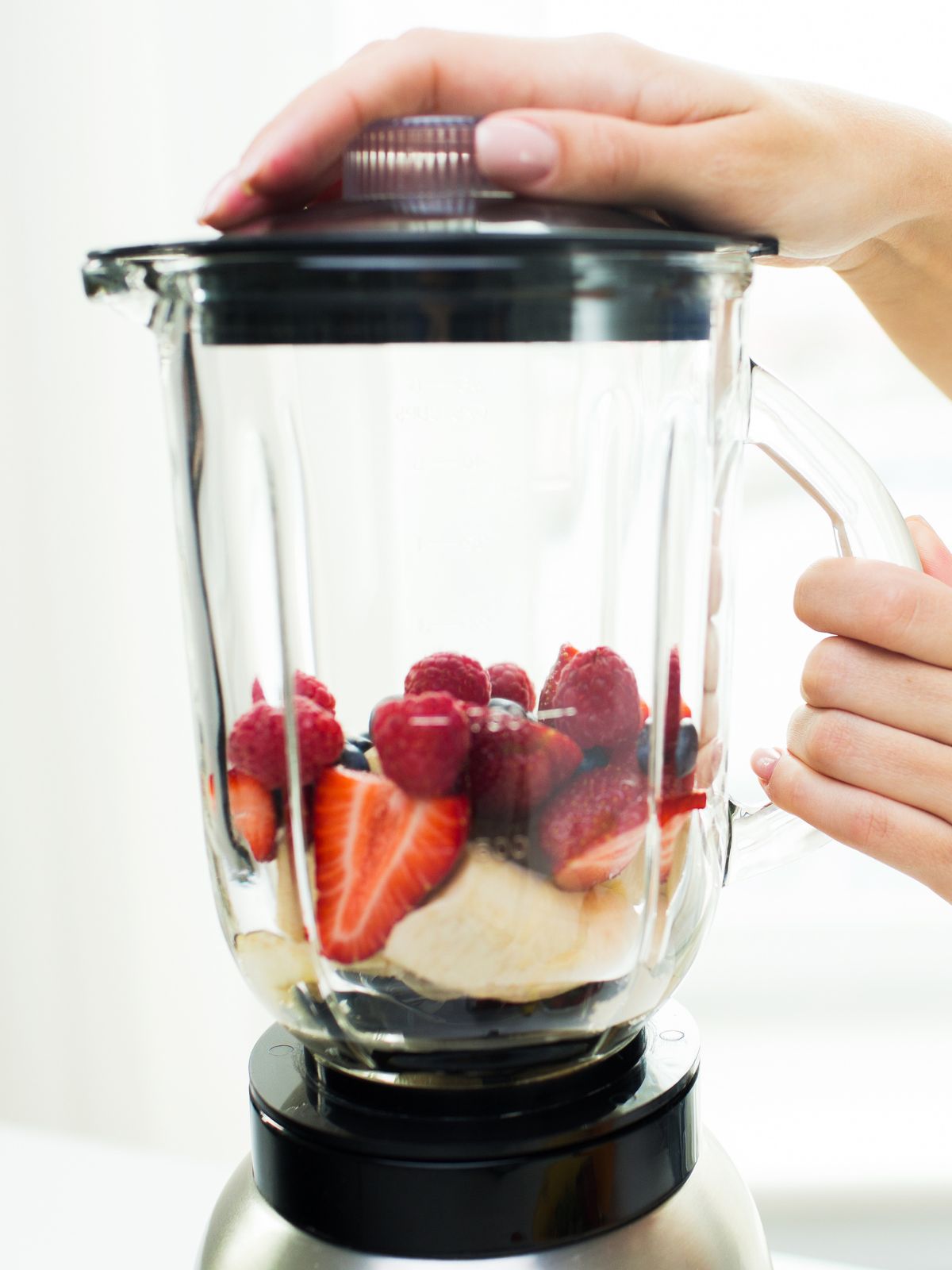 a blender with strawberries and banana in it.