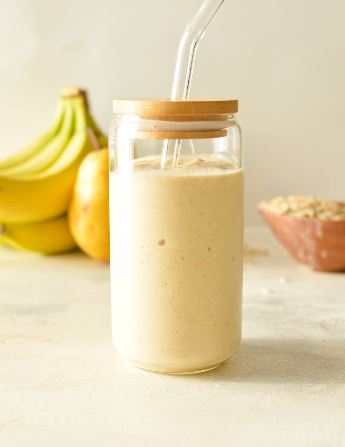 a pear banana smoothie in a glass.