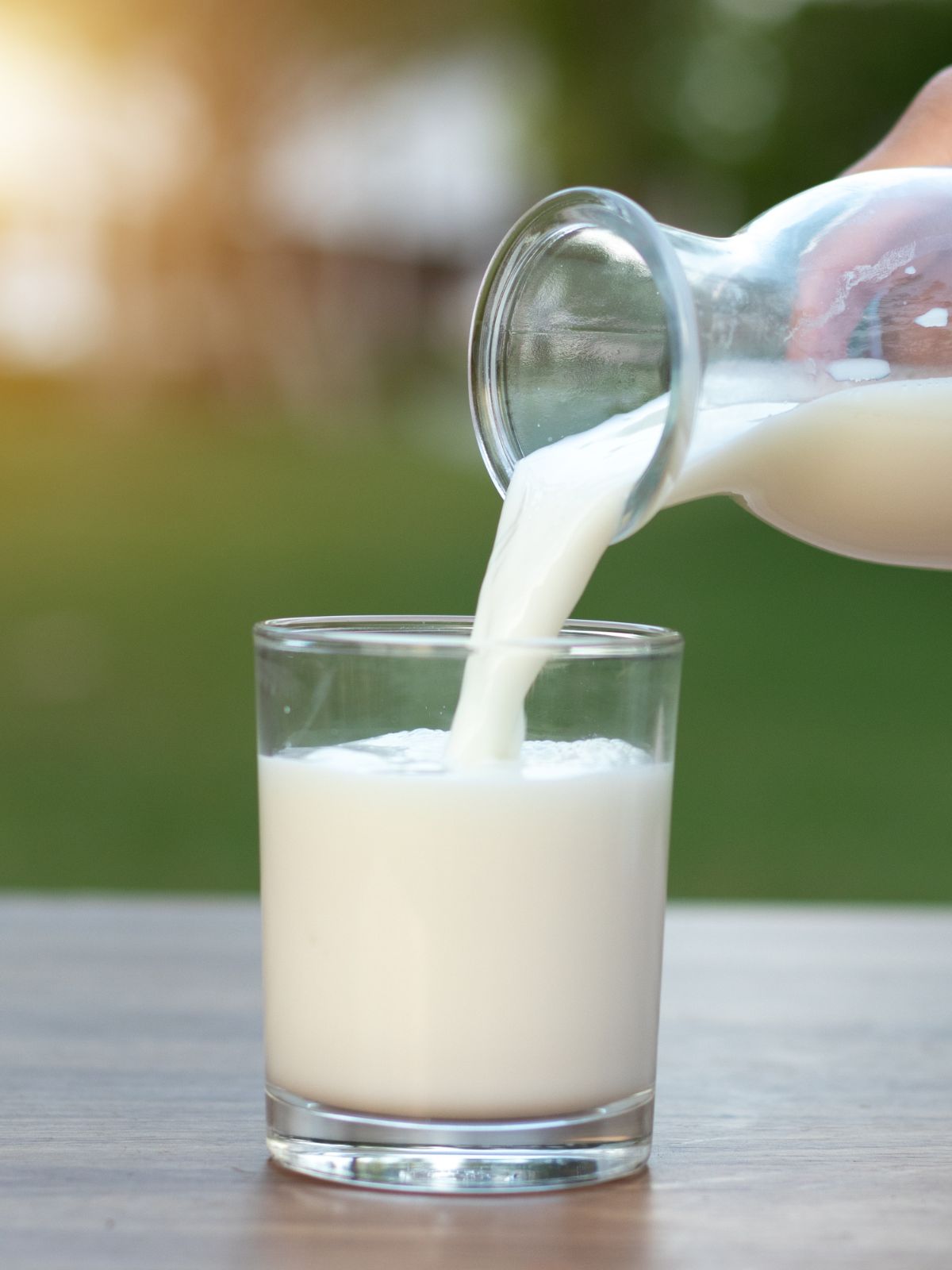 pouring a glass of milk.