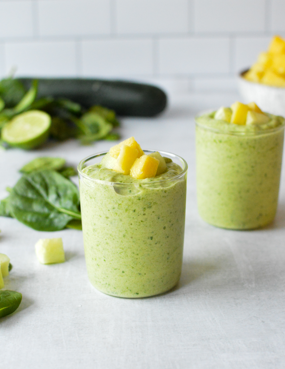 spinach cucumber smoothie with mango on top.