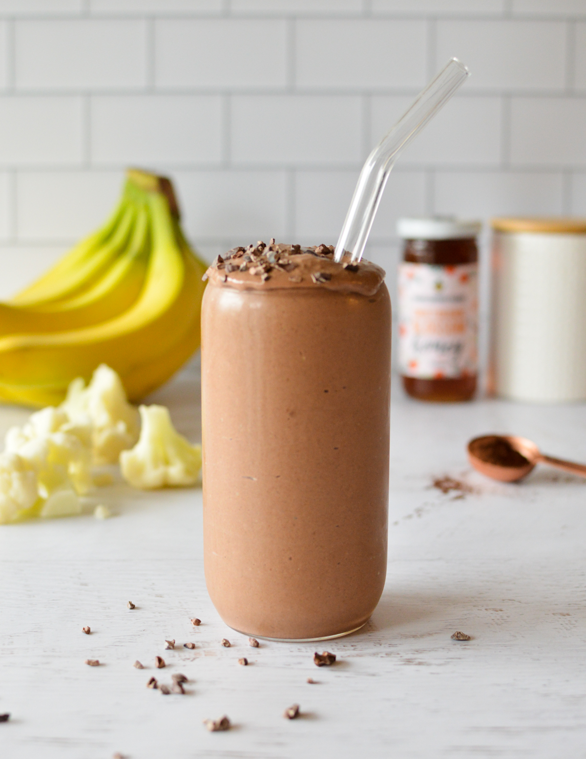 a chocolate smoothie with cocoa nubs on top. 