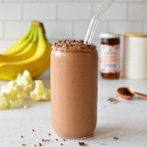 a chocolate smoothie with cocoa nibs on top,