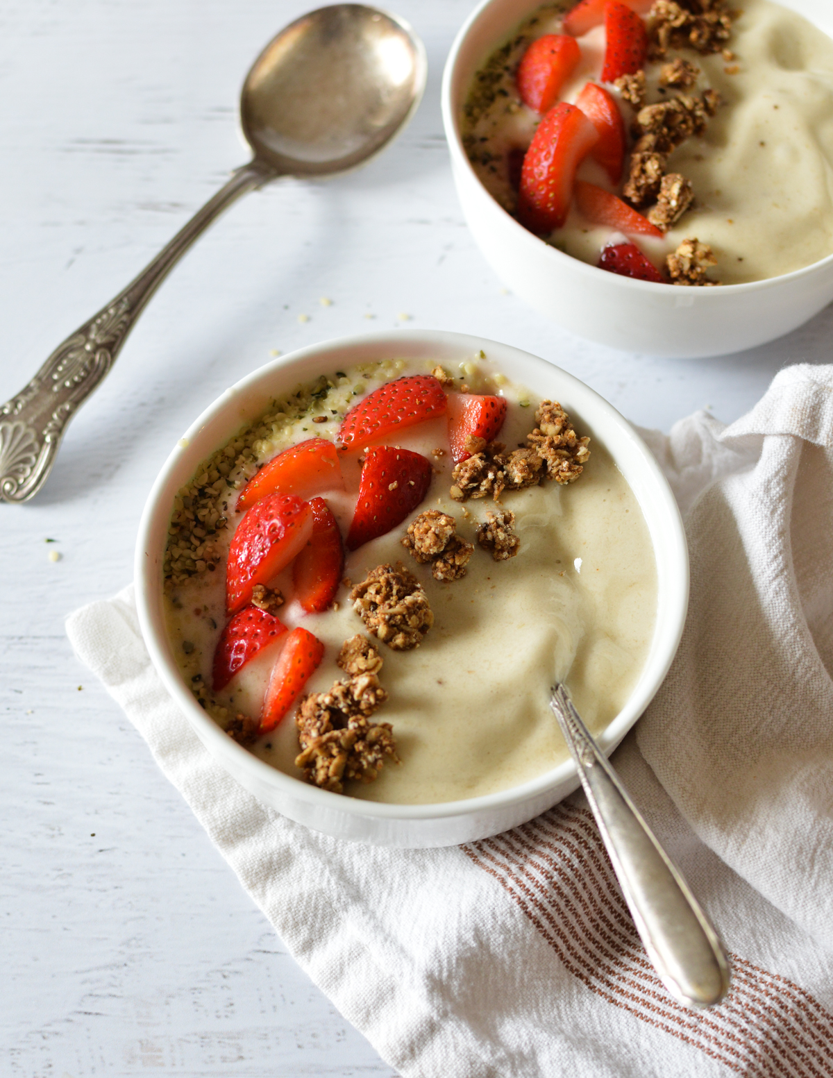 banana smoothie bowl with strawberries and granola.