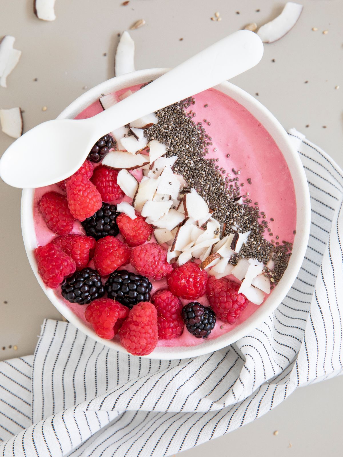 smoothie bowl with fresh berries, coconut, and chia seeds. 