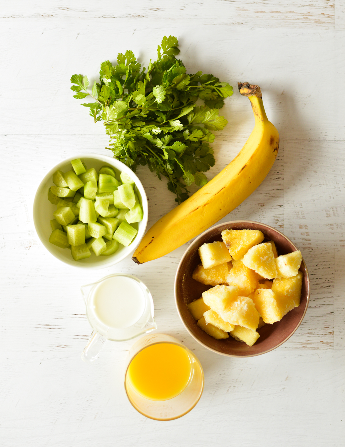 cilantro, banana, cucumber, pineapple, almond milk, and orange juice.