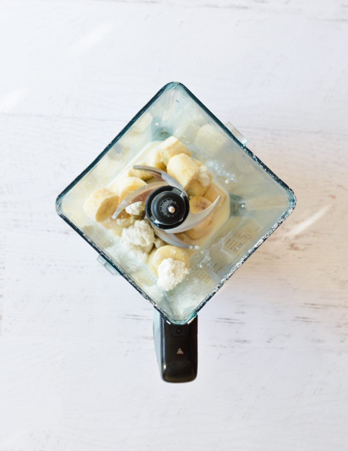 frozen bananas and coconut cream in a blender.