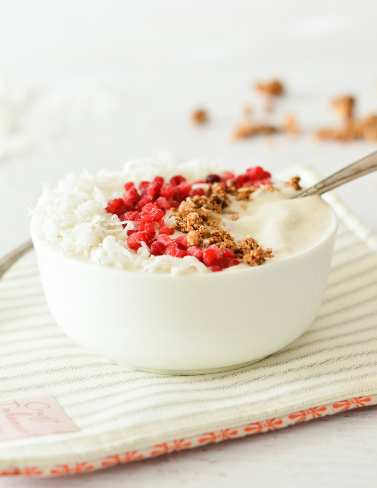 a coconut bowl with coconut, raspberries, and granola. 