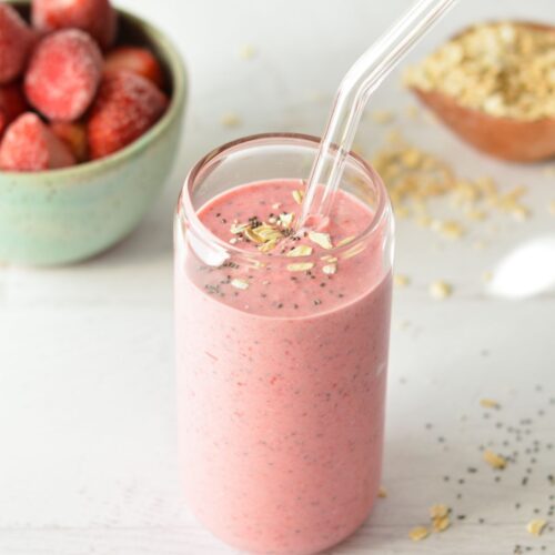 a raspberry smoothie with oats and chia seeds on top.