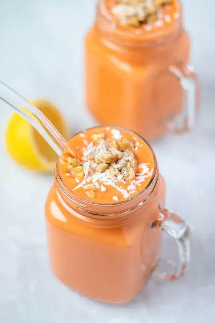 tropical carrot smoothie with coconut on top. 