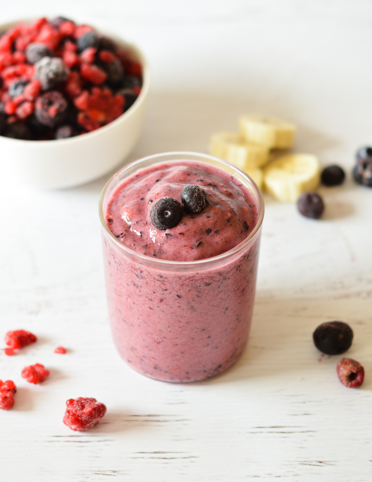 blueberry raspberry smoothie with blueberries on top. 