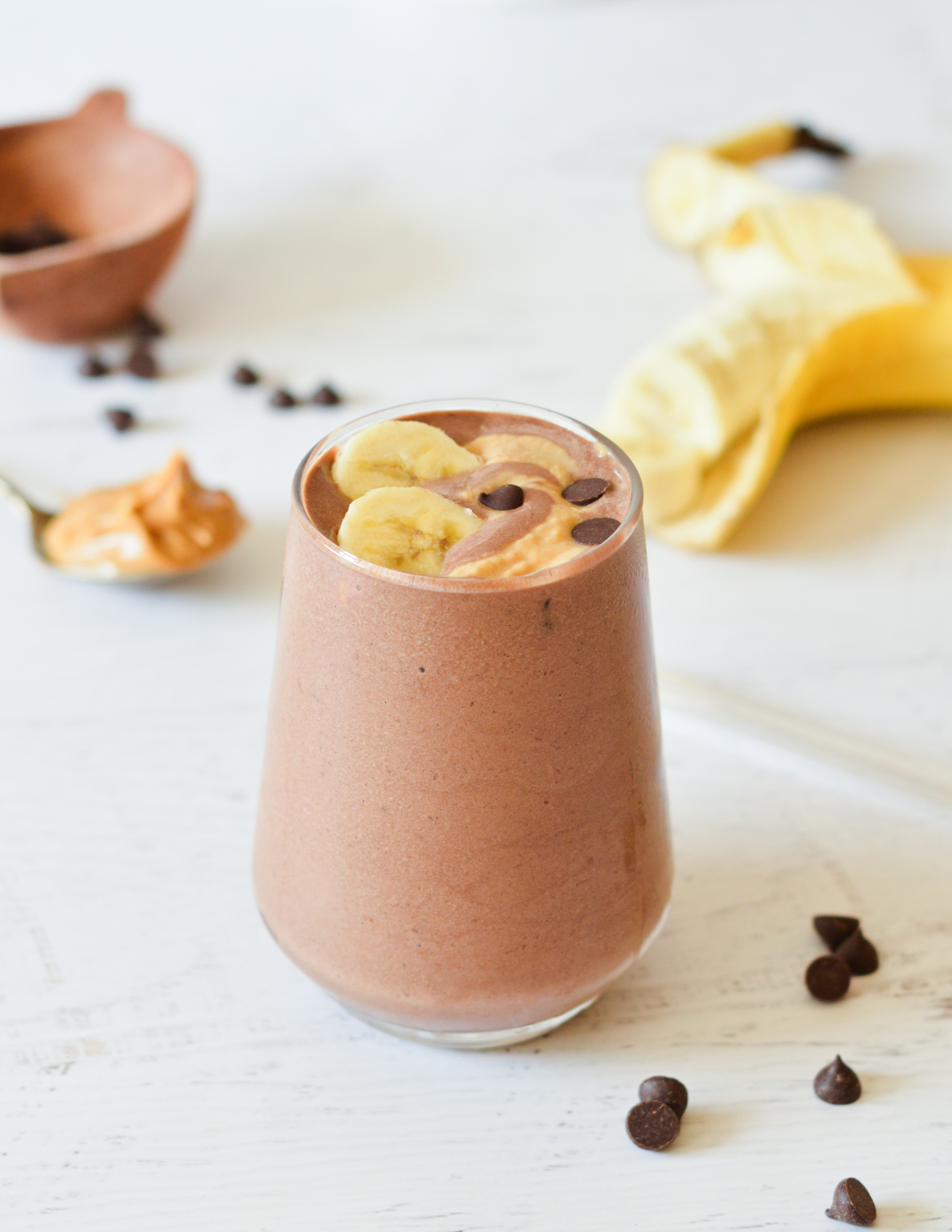 chocolate smoothie with bananas and chocolate chips on top.