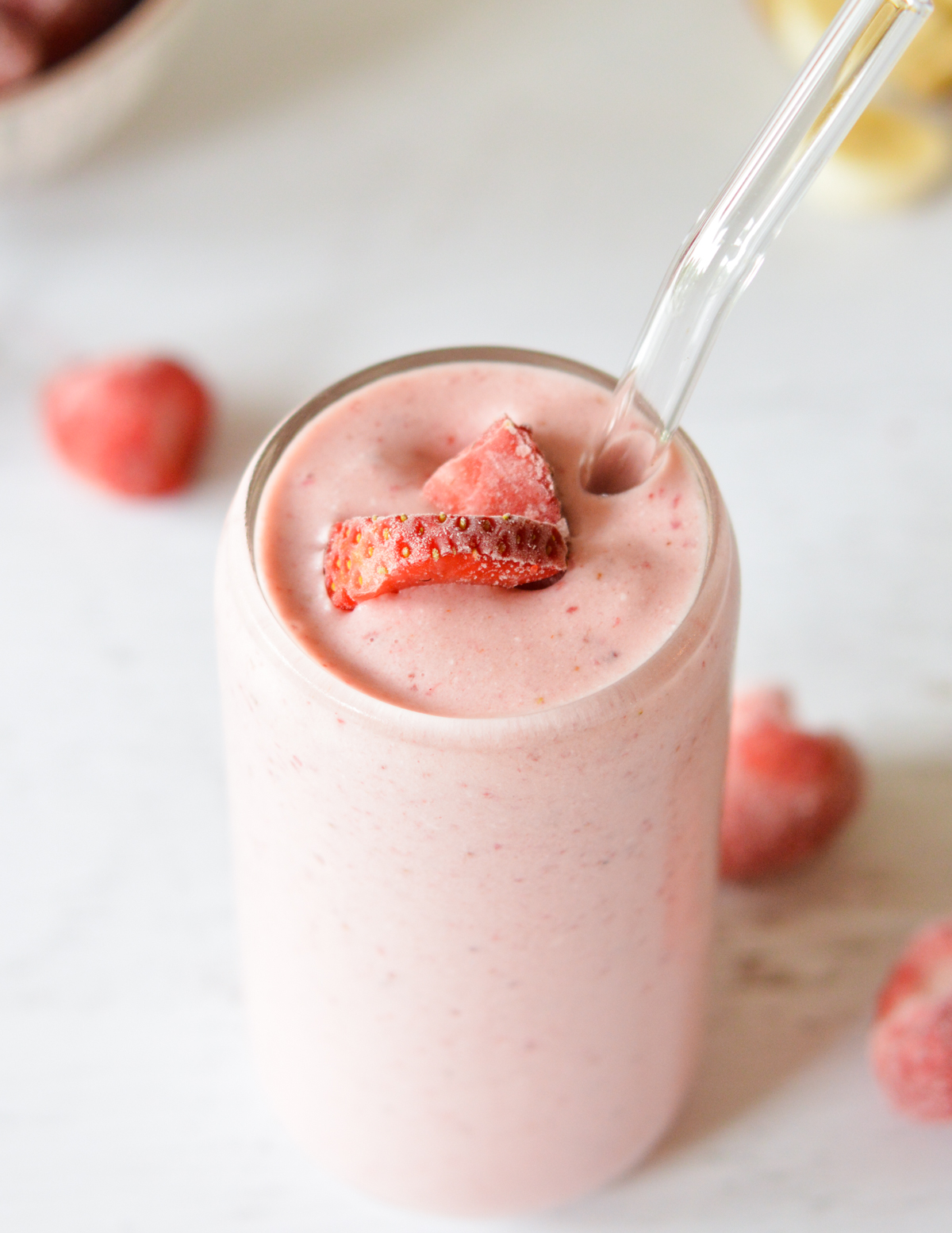 strawberry smoothie with strawberries on top.
