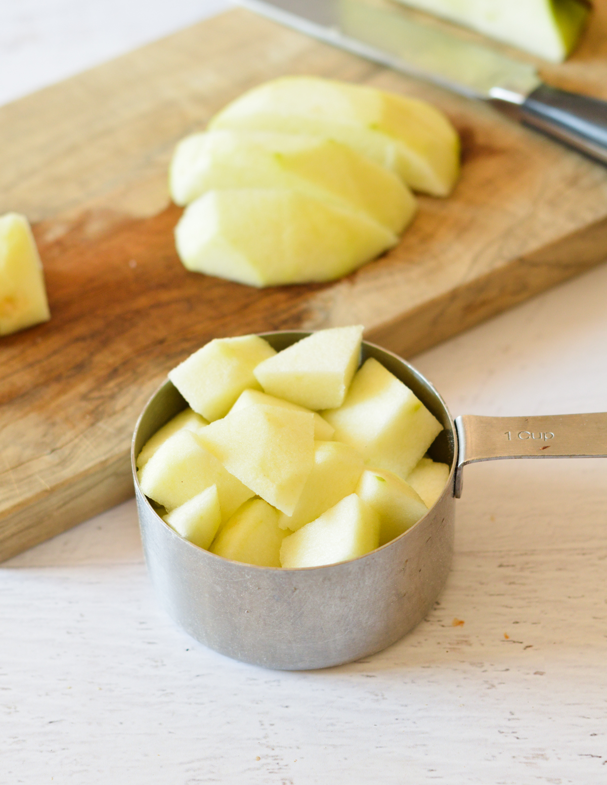 chopped green apple in a measuring cup. 