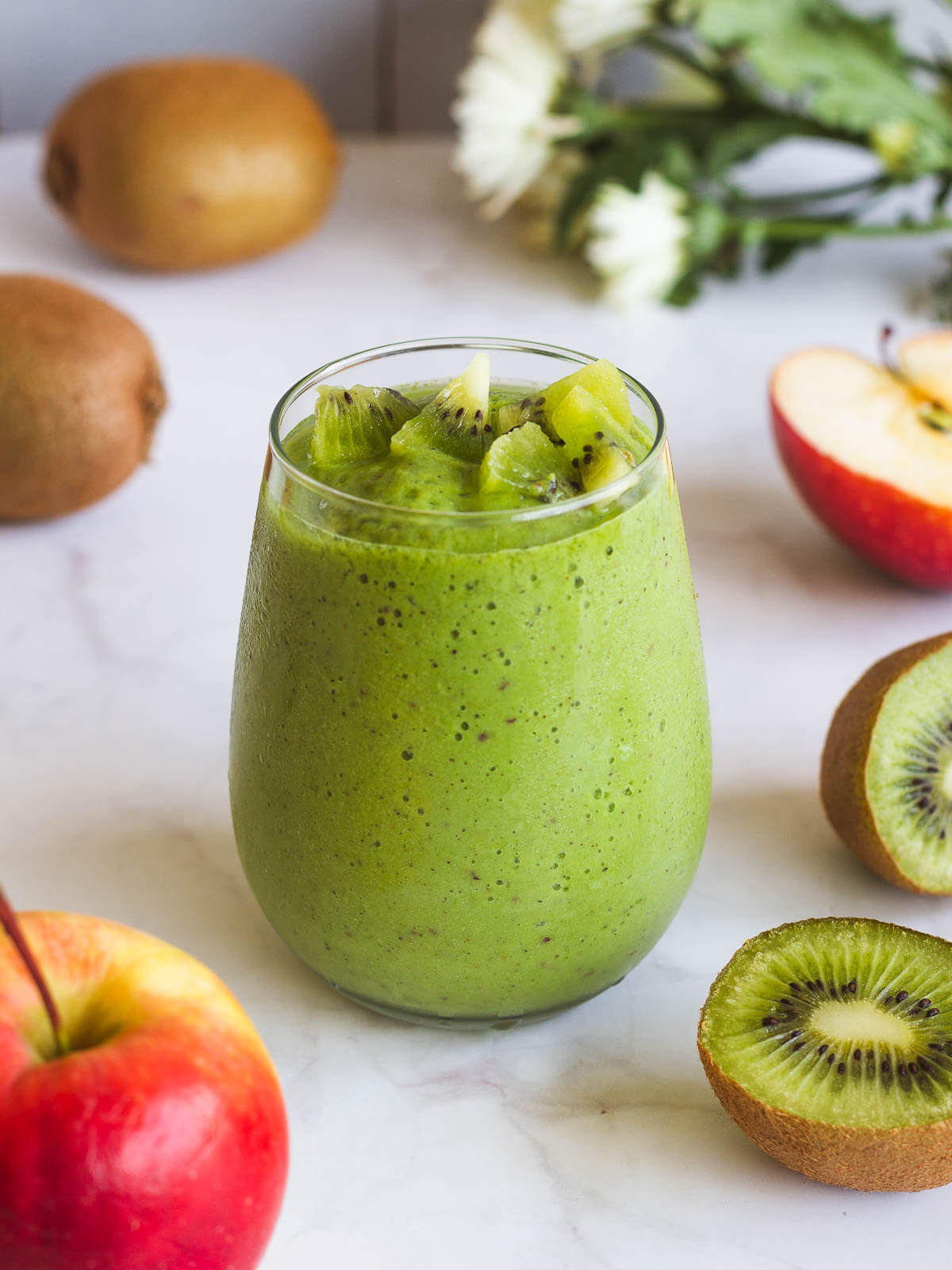 spinach apple smoothie with kiwi on top.