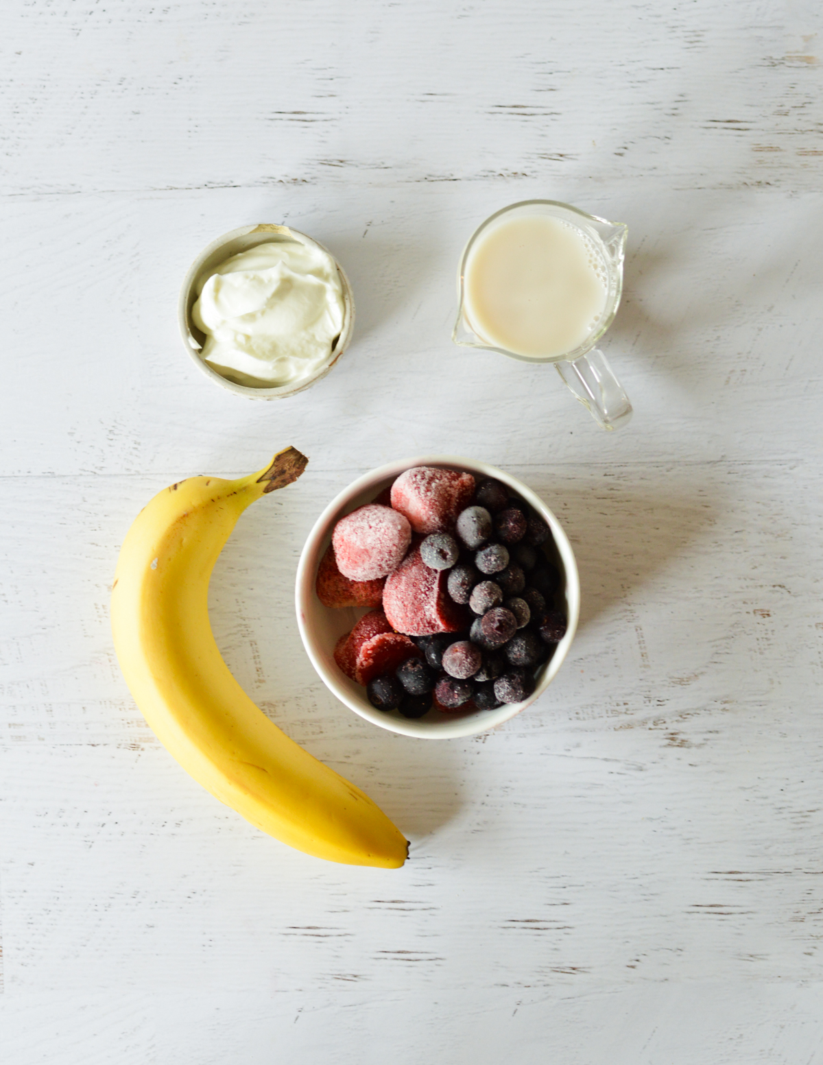 greek yogurt, almond milk, banana, frozen blueberries, frozen strawberries. 