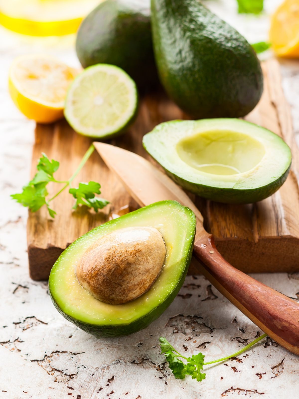 avocado cut in half with a knife.