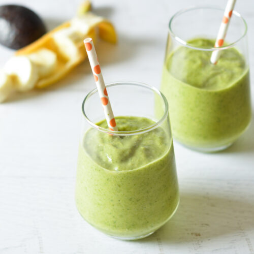 frozen spinach smoothies with straws.