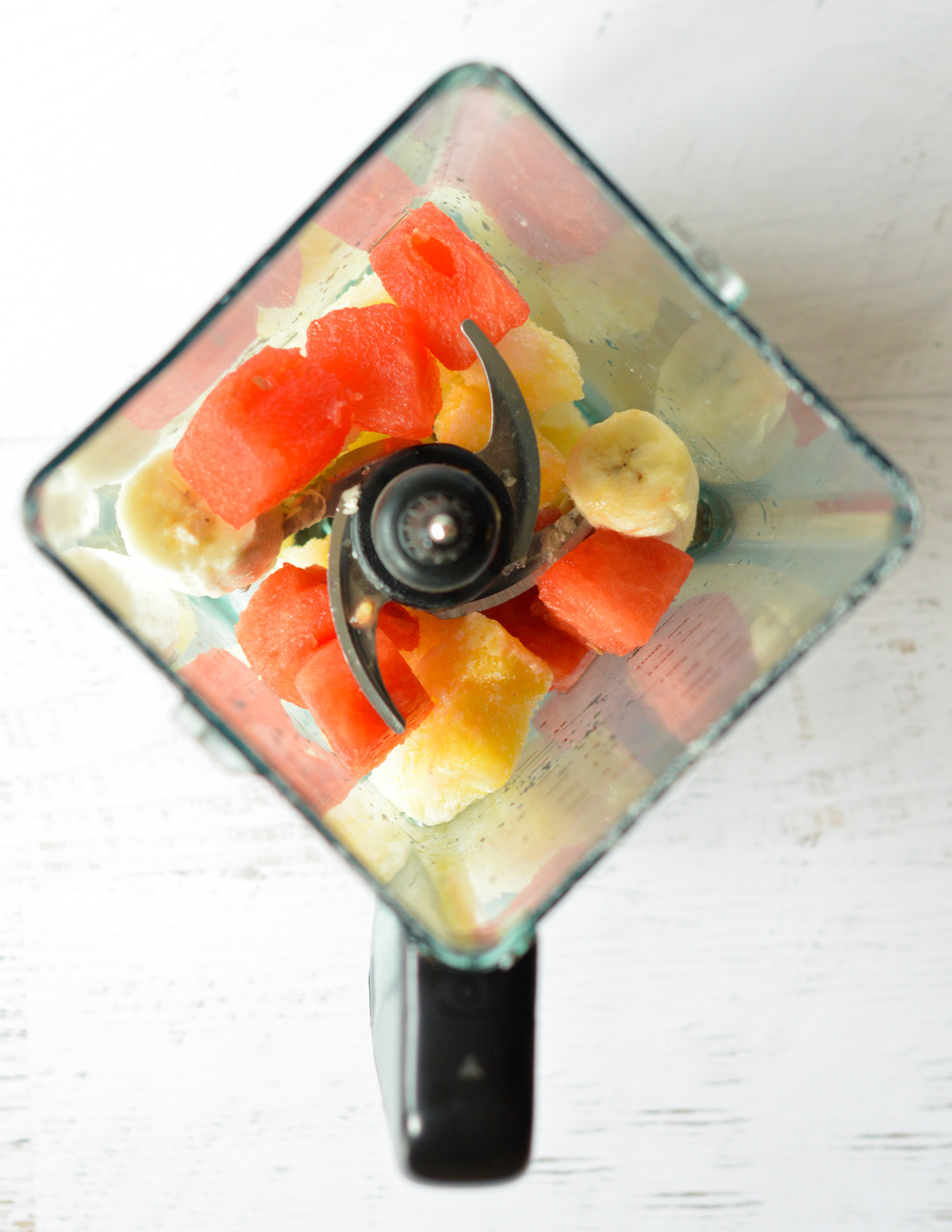 pineapple, watermelon, and banana in a blender.