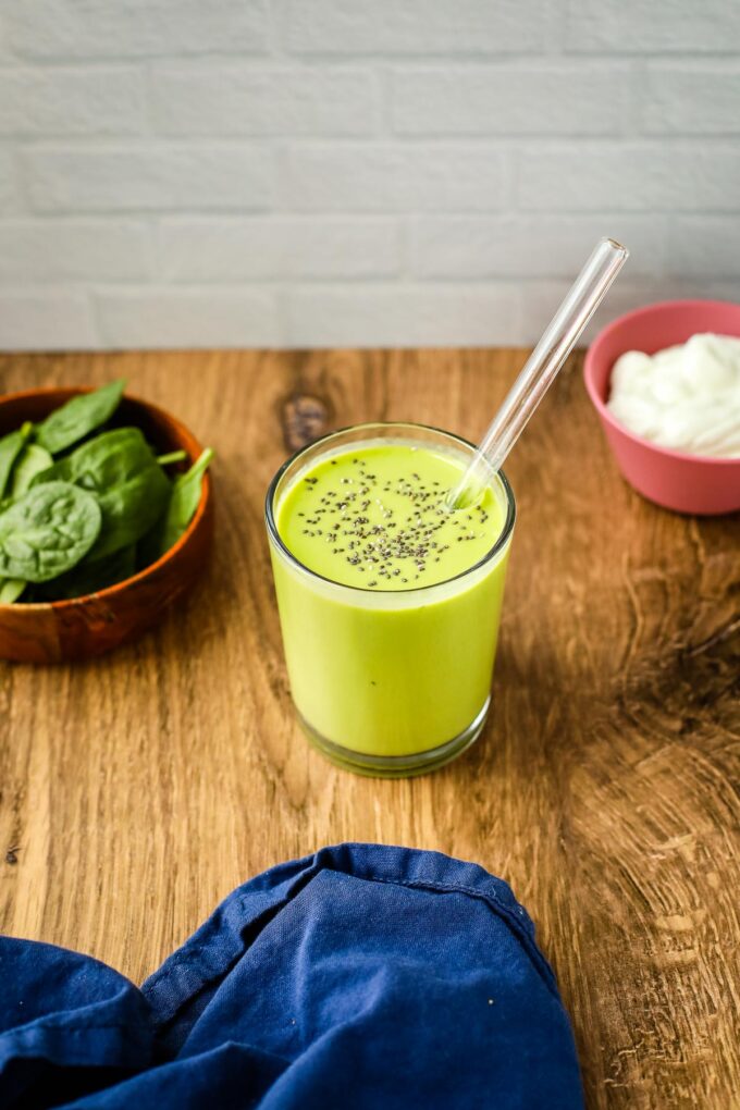 green smoothie on wood counter.