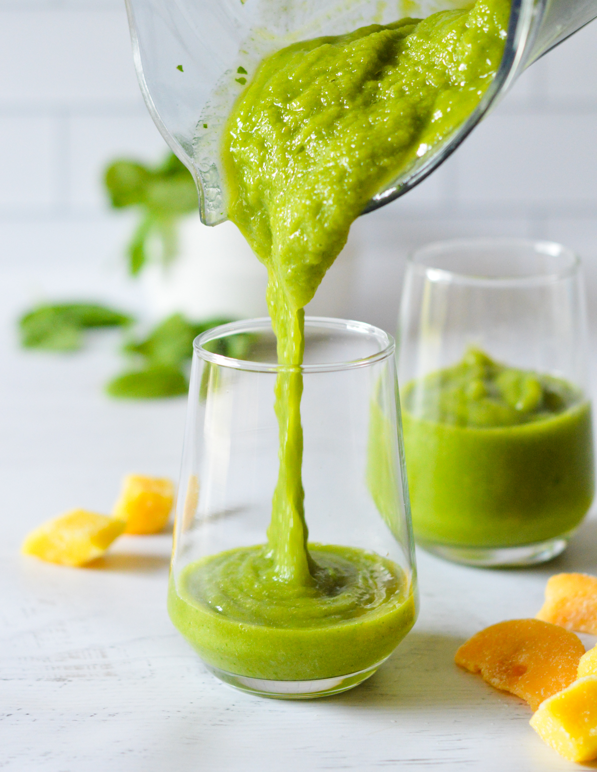 pouring a green passion smoothie.