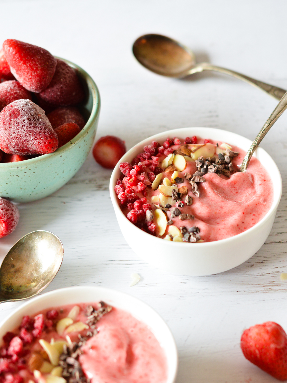strawberry smoothie bowls with toppings.