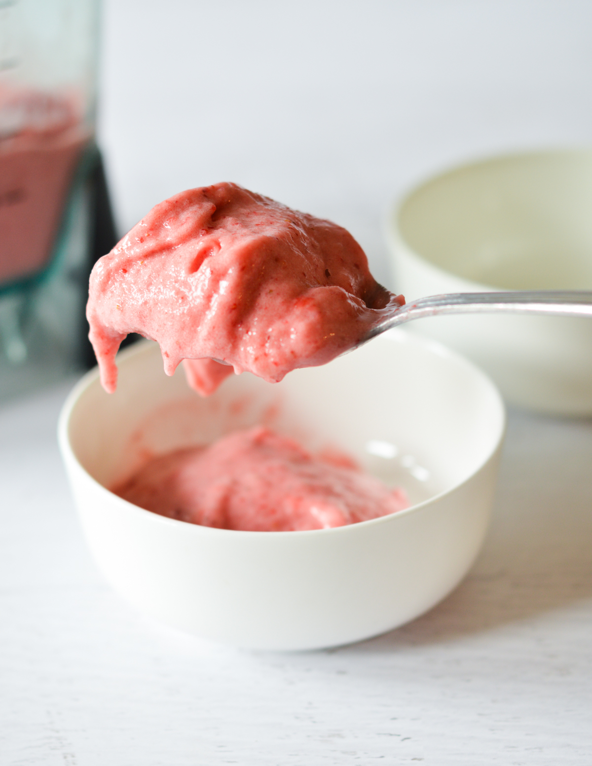 a spoonful of strawberry smoothie.