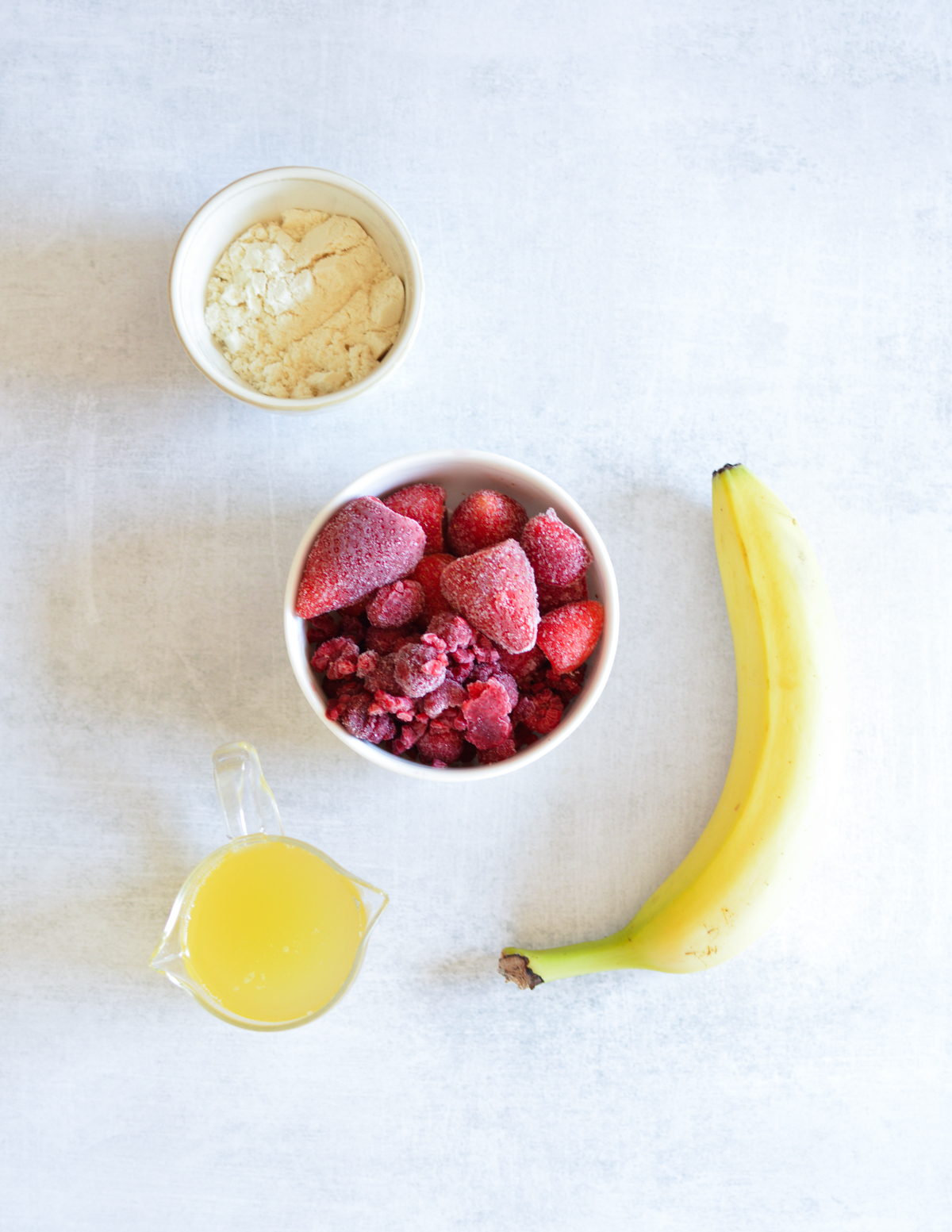 vanilla protein, banana, frozen strawberries, frozen raspberries, juice.