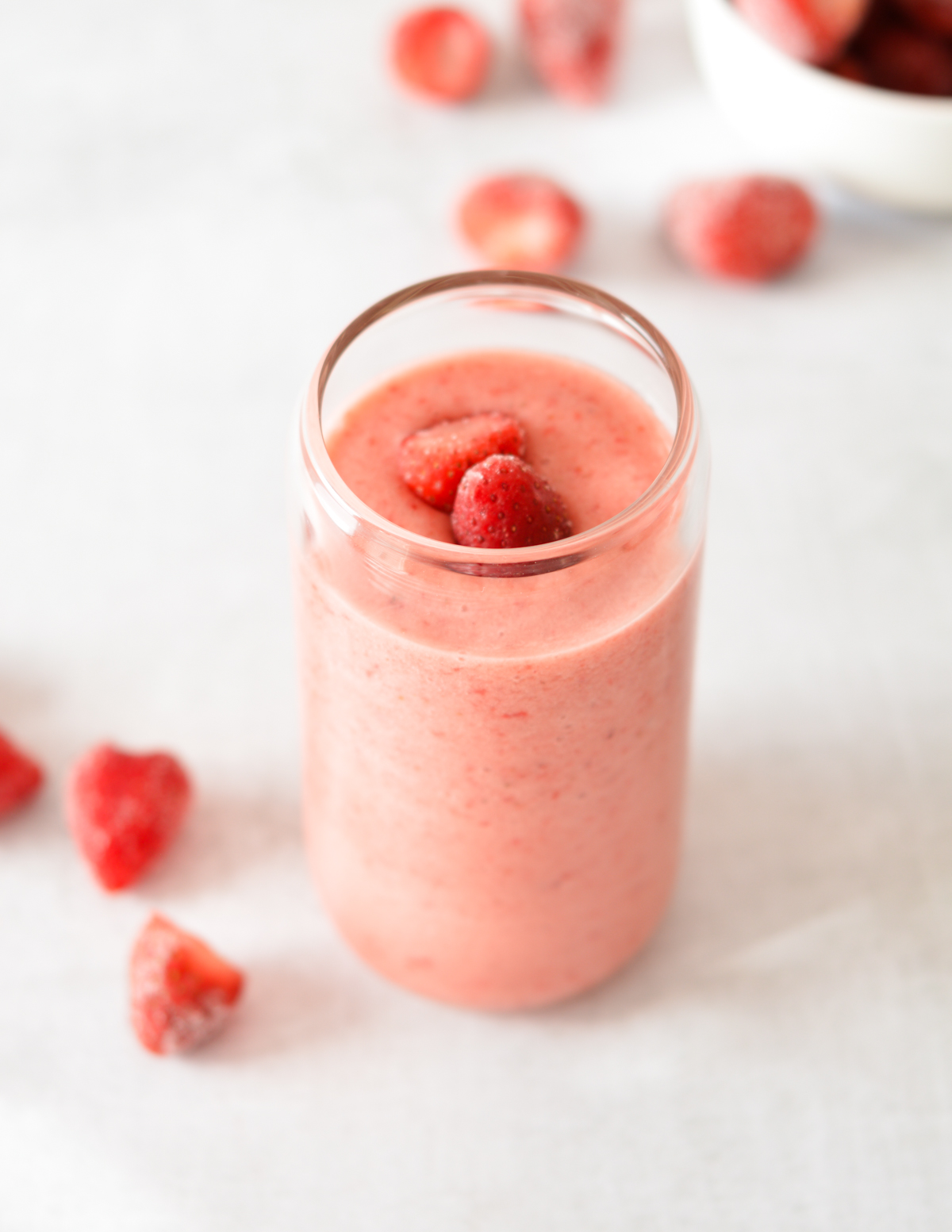 top of a strawberry smoothie with strawberries on top.