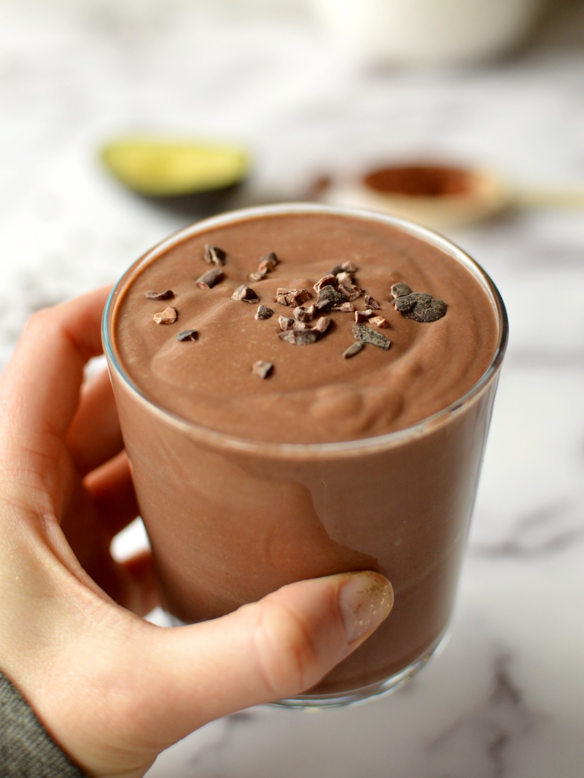 chocolate smoothie with cacao nibs on top.