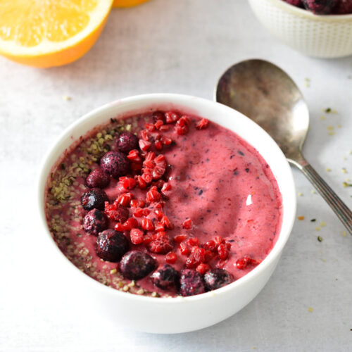 berry smoothie bowl with berries and hemp hearts on top.