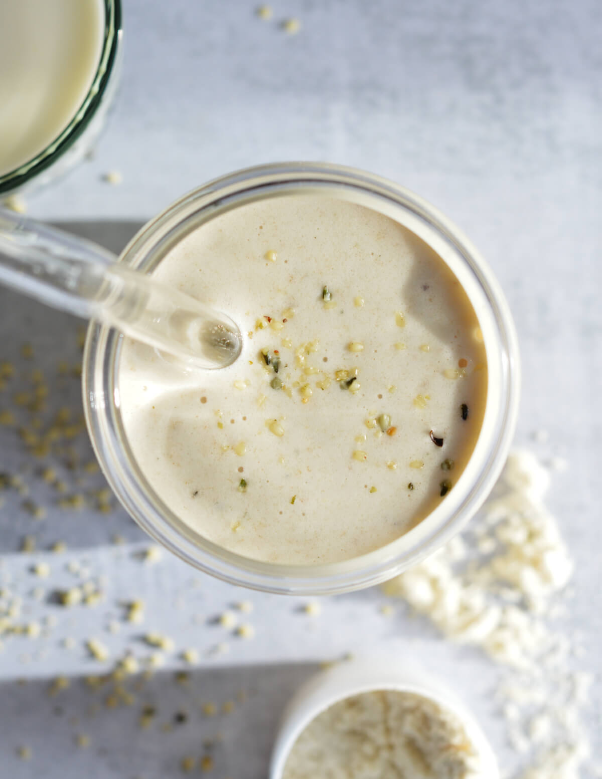 top of a banana smoothie with hemp seeds on top.