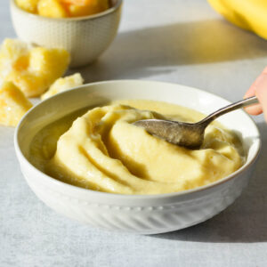 pineapple smoothie bowl with a spoon in it.